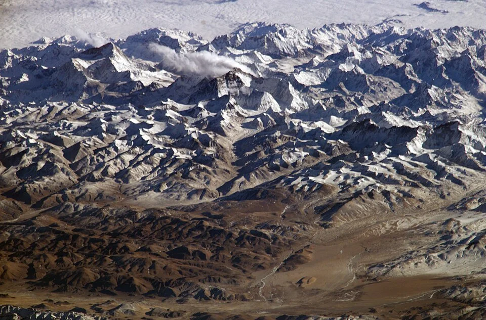 Himalayas photographed from the International Space Station, looking south from over the Tibetan Plateau, according to NASA metadata.