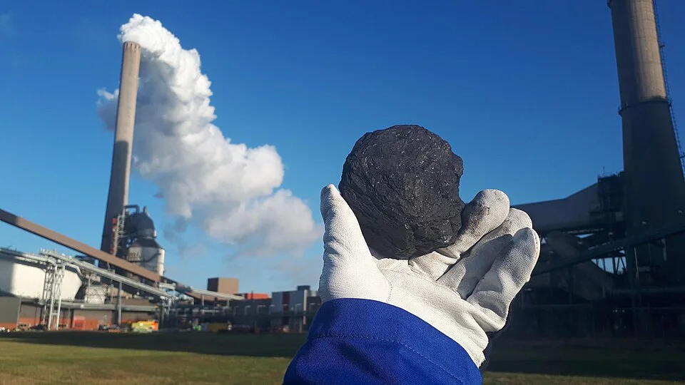 Coal held before a coal-fired power plant in the Netherlands; a comparative illustration of coal-based electricity generation.