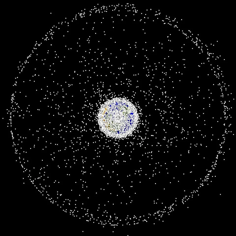 NASA computer-generated polar-view plot of tracked Earth-orbiting objects, with markers enlarged for visibility.