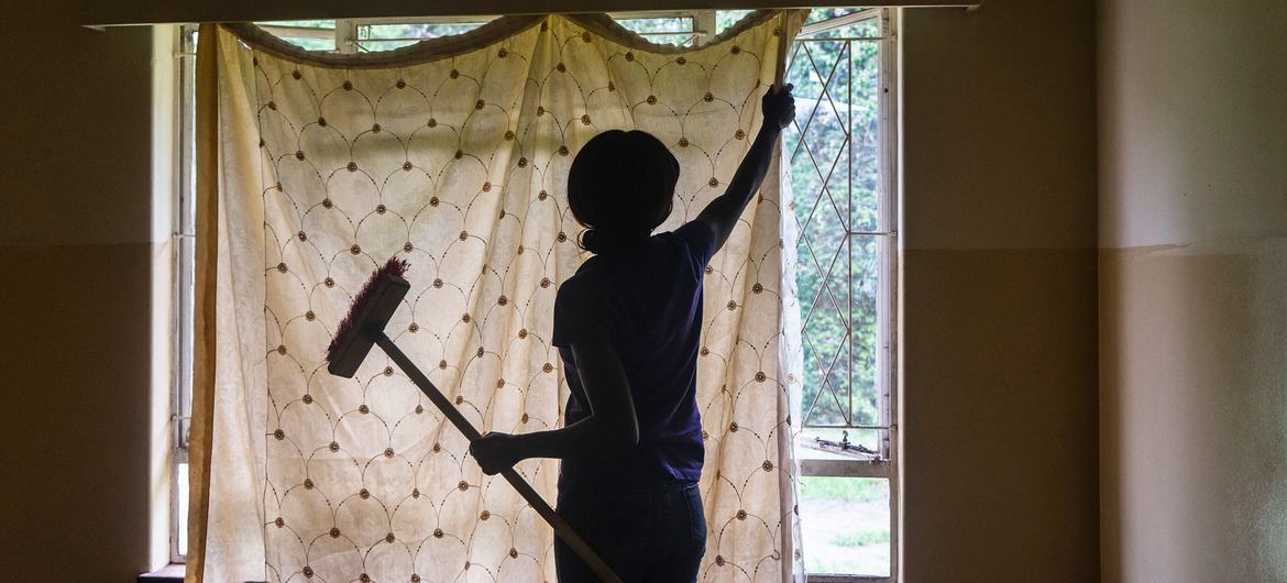 Reference view of a domestic worker cleaning a house in Harare, Zimbabwe, illustrating the household labour at the centre of debates over formal employment and labour protection.